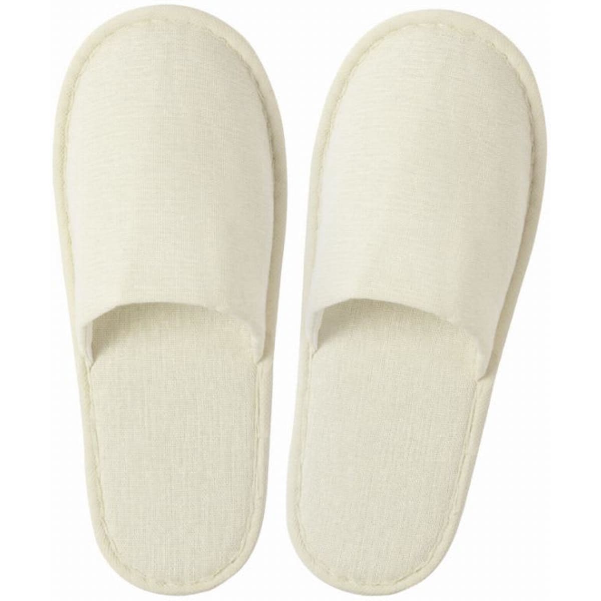 A pair of cream-coloured spa slippers with open toes and soft fabric. They have a simple, elegant design.