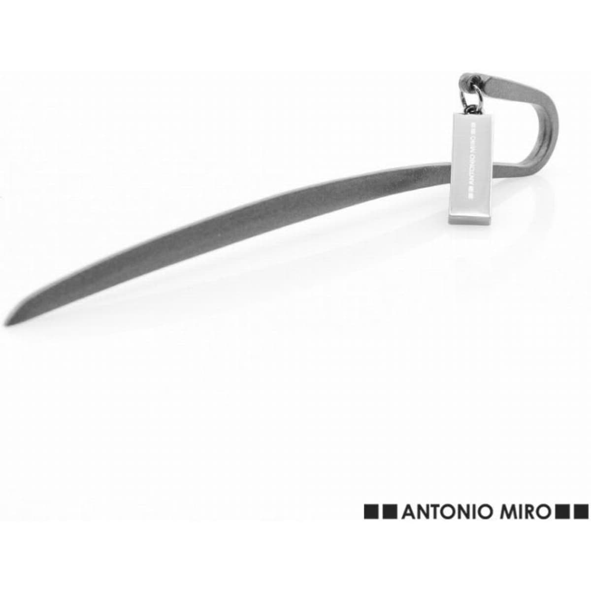 A sleek, silver metal bottle opener with a curved design and an attached tag.
