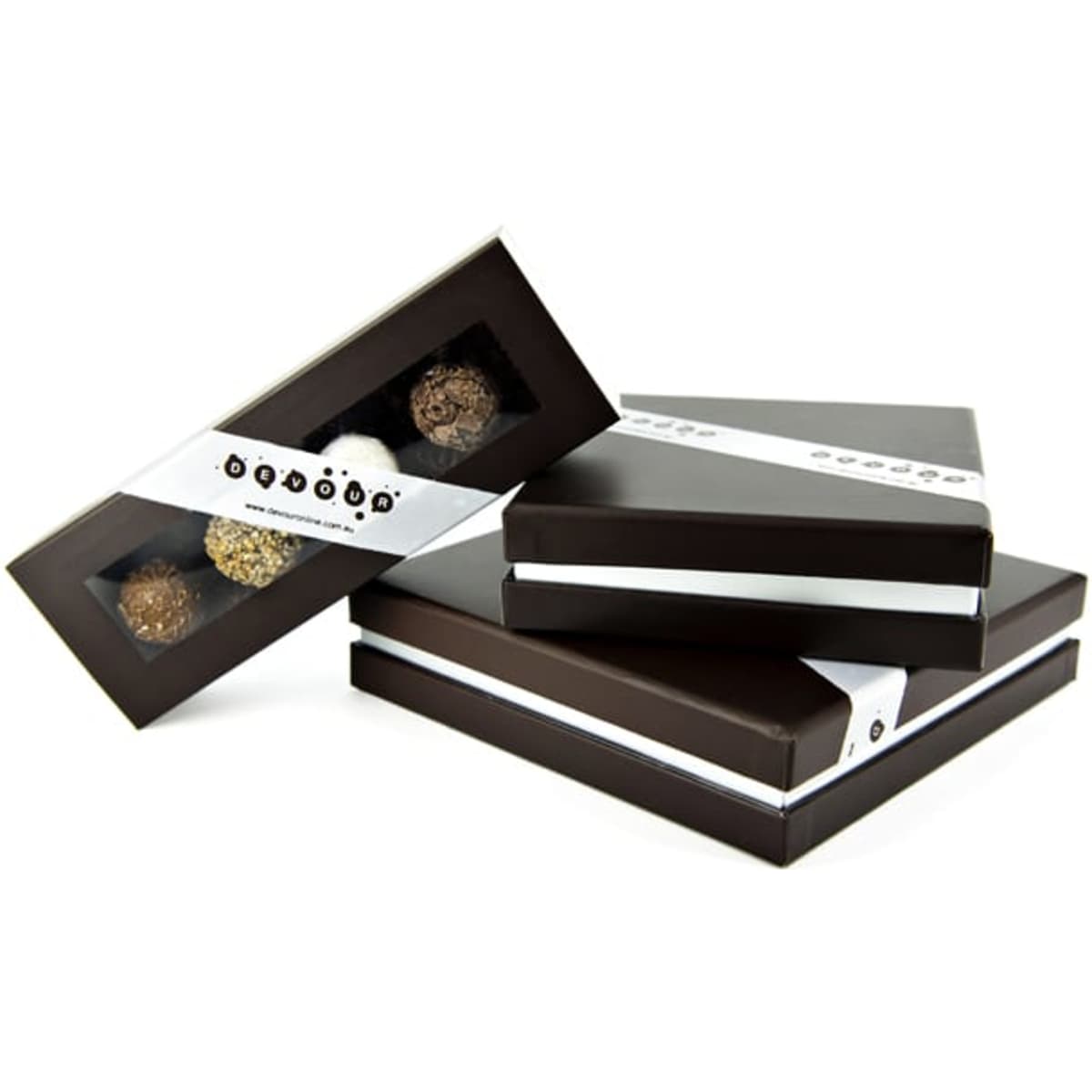 A stack of three dark chocolate boxes with transparent windows, showcasing assorted chocolates inside. Each box is elegantly tied with a ribbon.