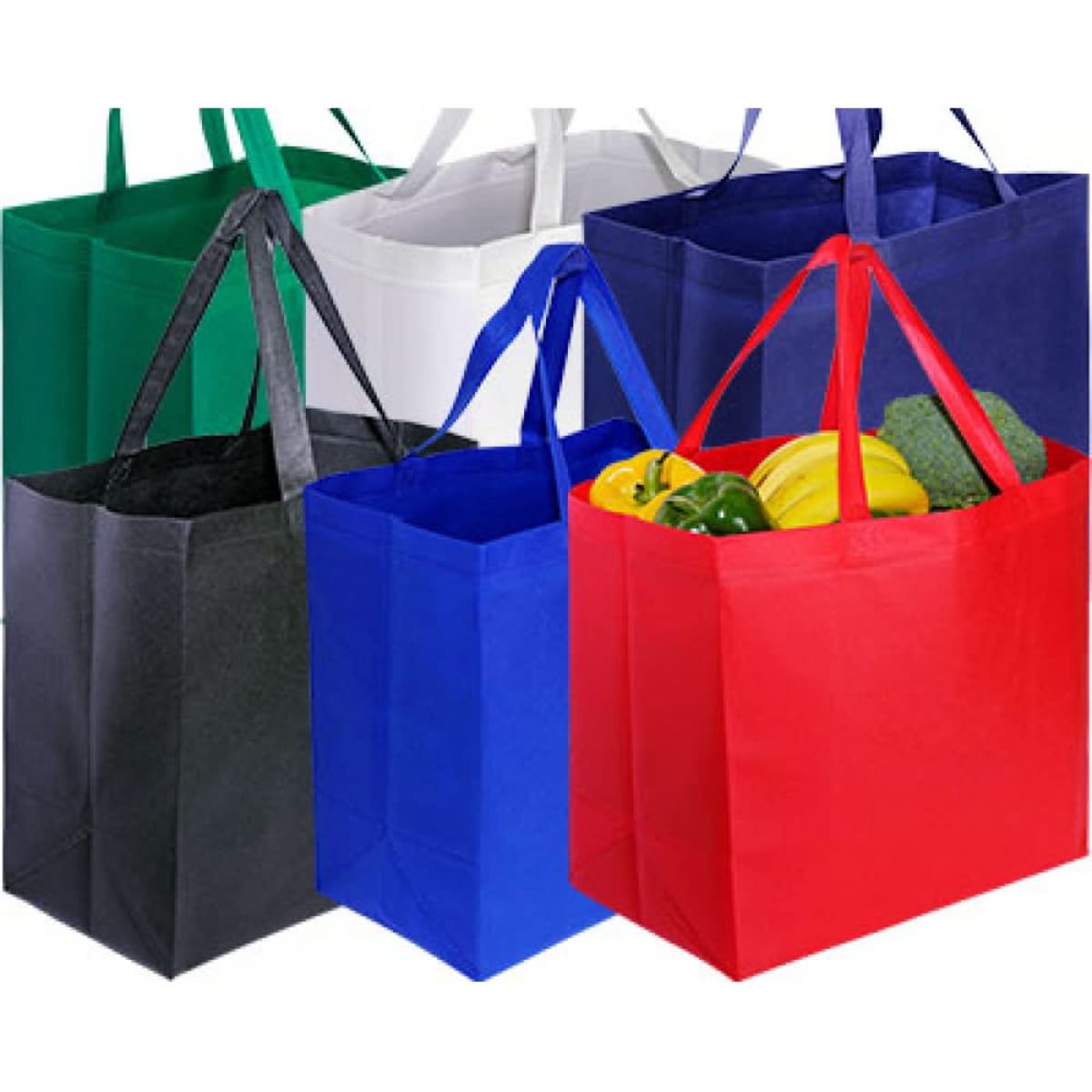 A collection of large shopping bags in green, white, black, blue, and red, filled with assorted vegetables.
