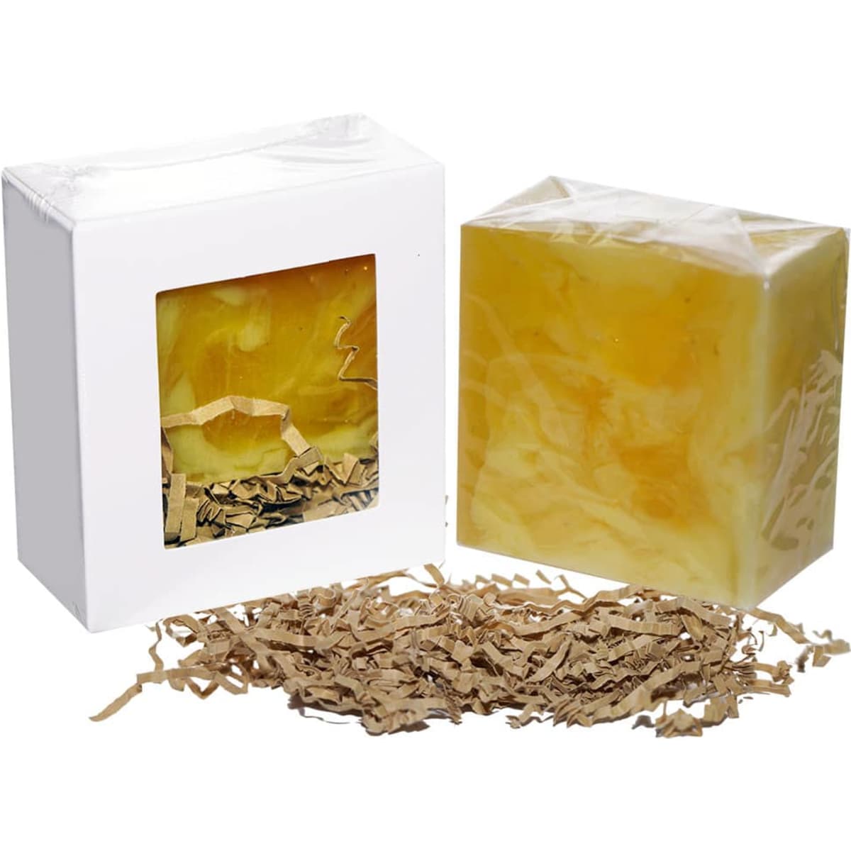 A soap bar in a clear package, yellow in colour, accompanied by shredded paper packing material.