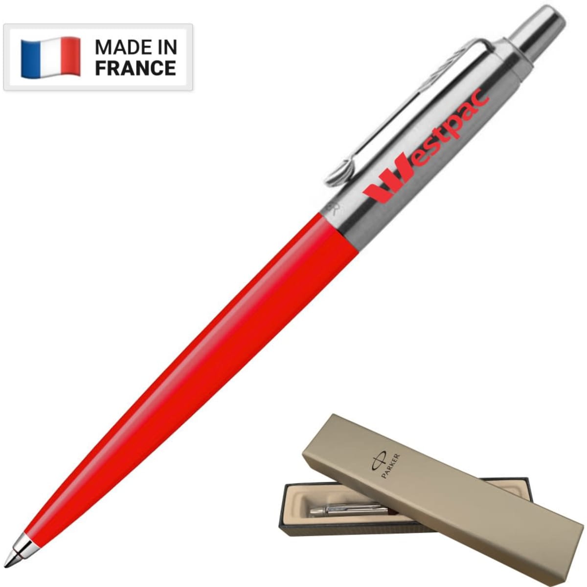 A metal ballpoint pen in red with a silver clip, presented in a beige box, featuring a brand logo.