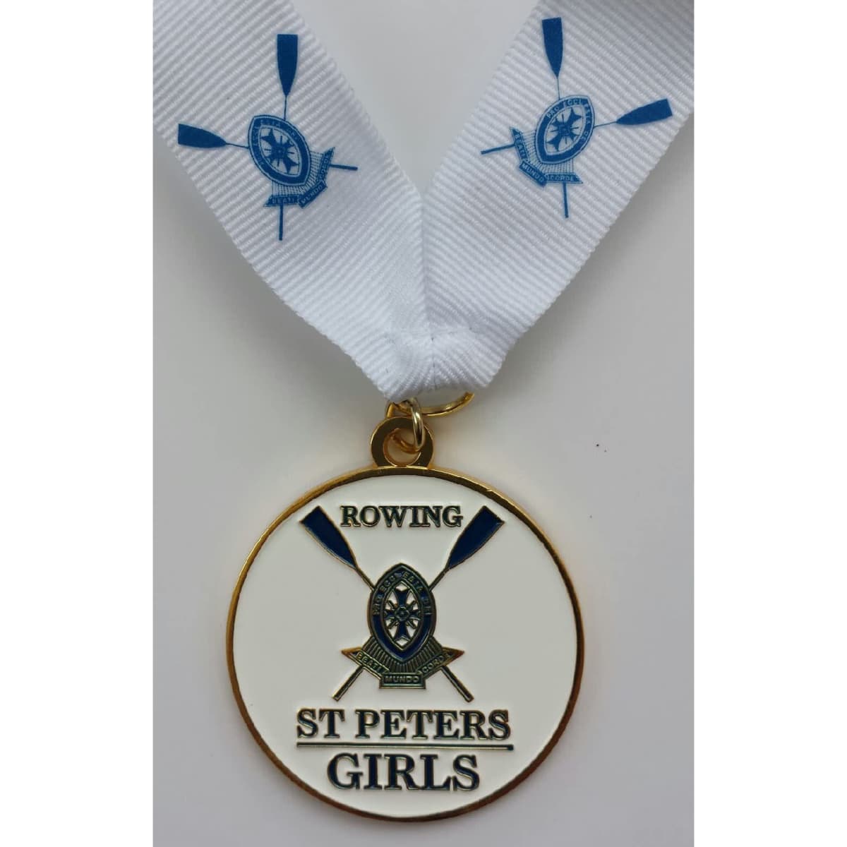 A gold medal with a white ribbon featuring blue rowing oars and the text "Rowing St Peters Girls".