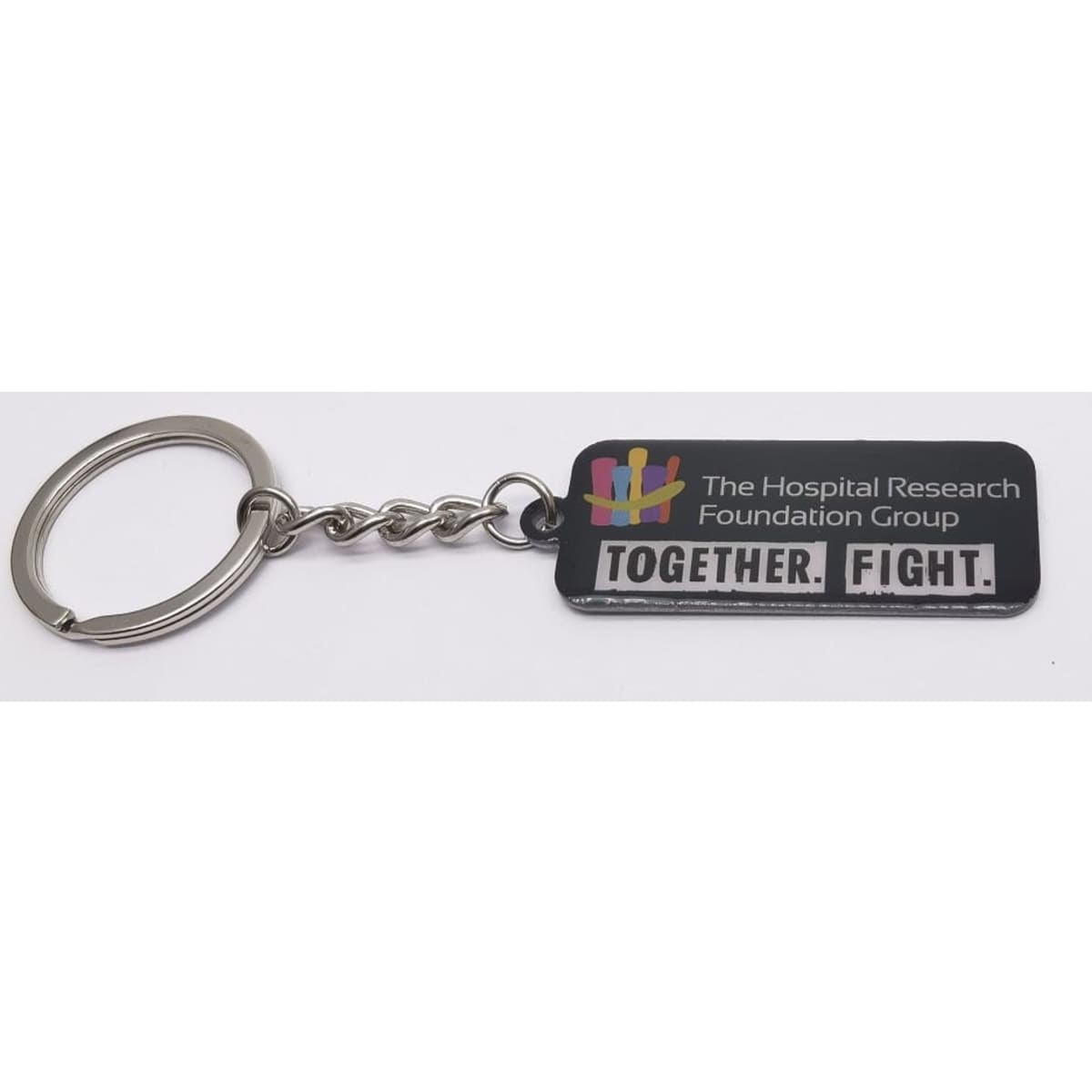A metal keyring featuring a rectangular black tag with a logo and the text "TOGETHER. FIGHT."