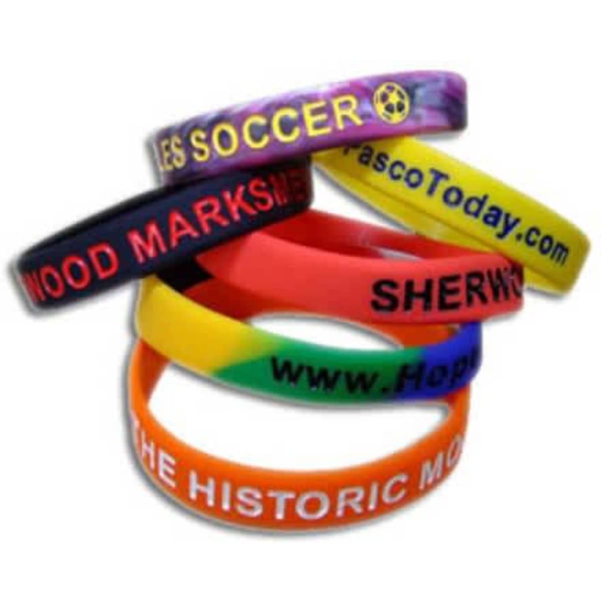 Five silicone wristbands in various colours, featuring text and a logo on each band.