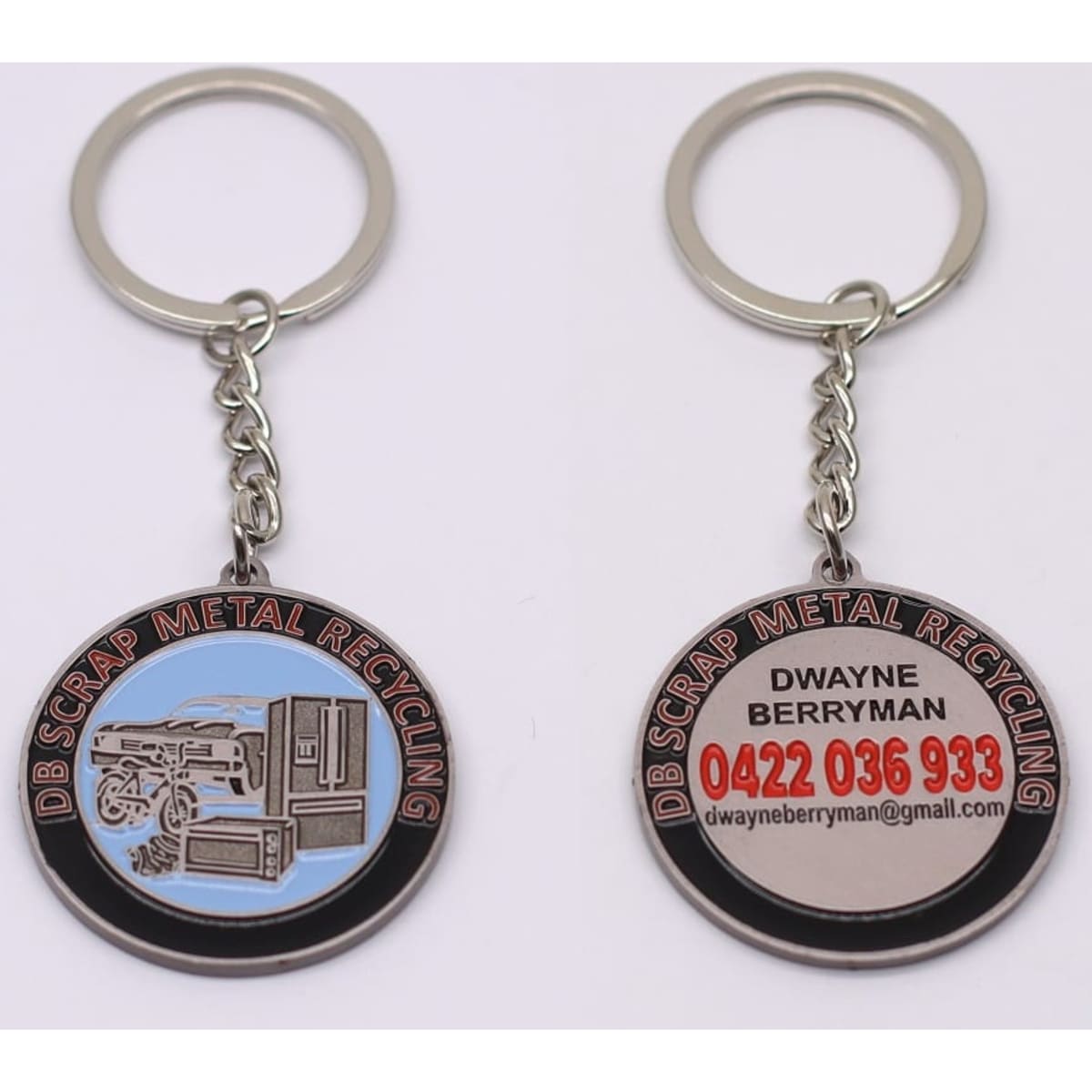 A metal keyring featuring a distinct design, with blue and silver colours, and branding on both sides.