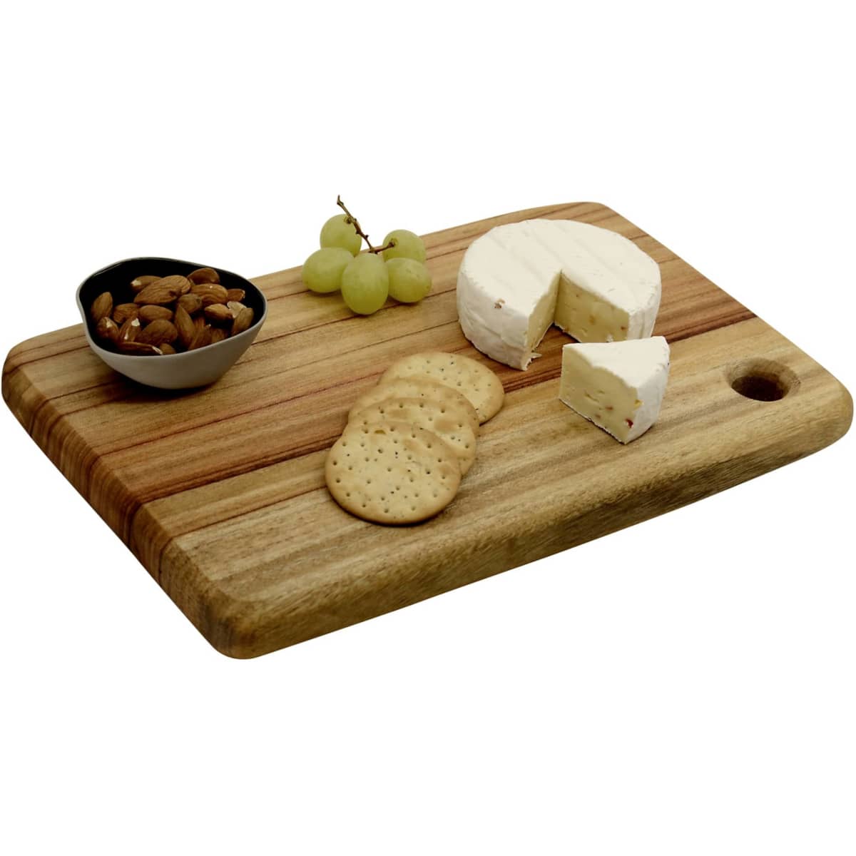 A wooden cheese board with a creamy cheese wheel, crackers, almonds, and grapes, featuring a small bowl.