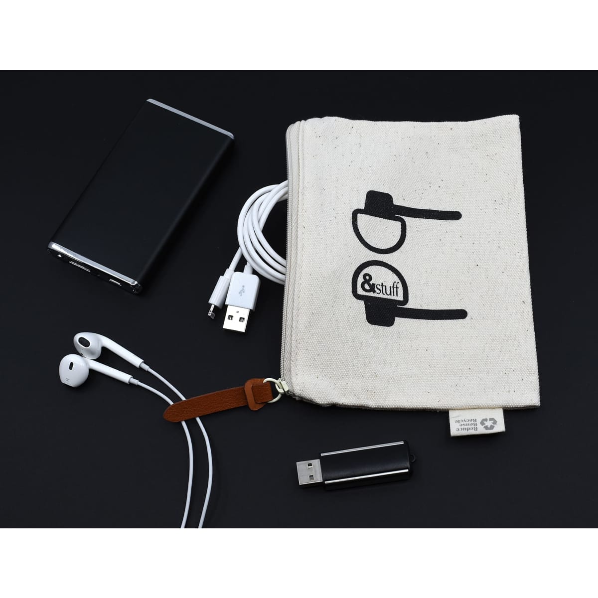 A neutral calico earphone pouch with a logo, surrounded by earphones, USB cables, and a portable charger.