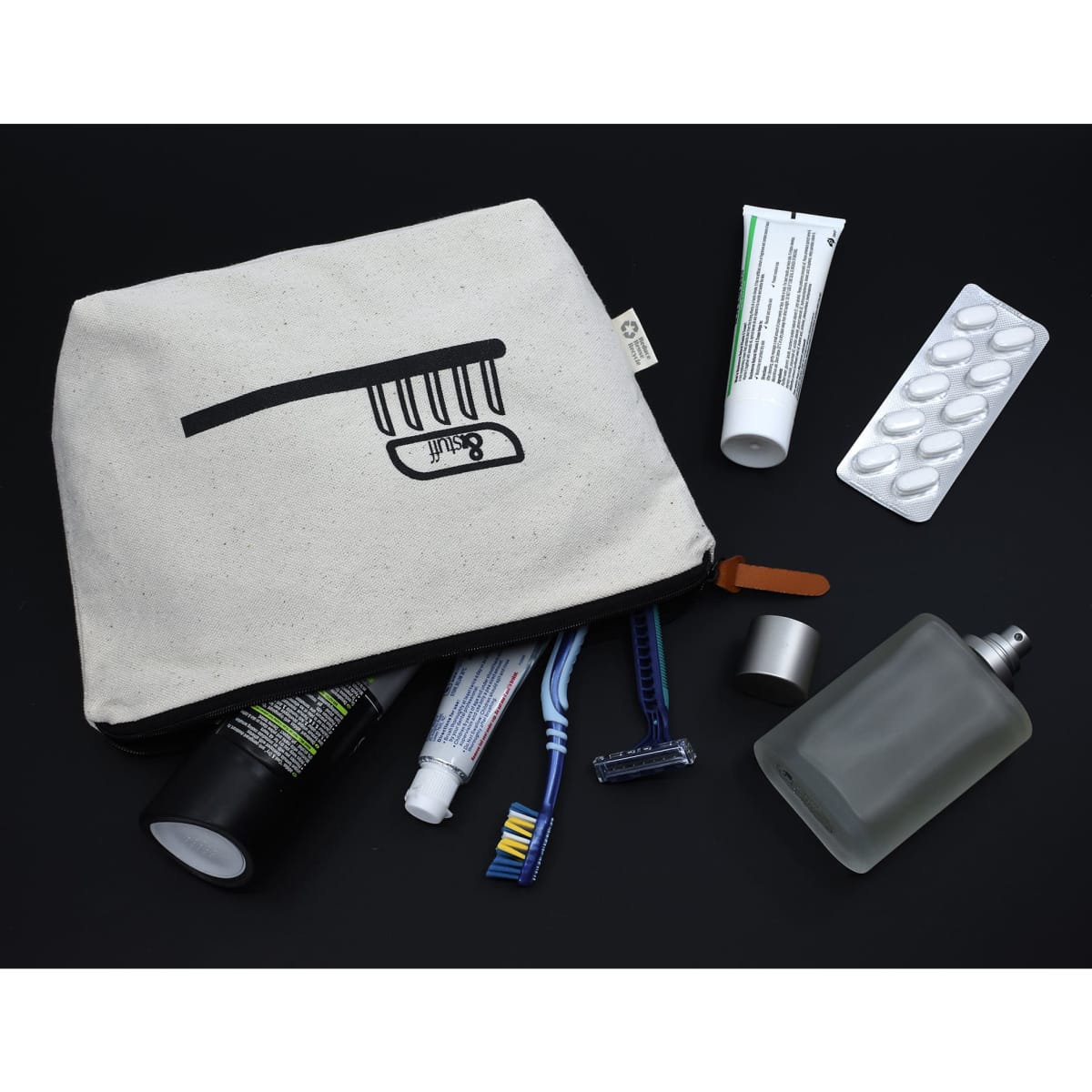 A cream-coloured toiletry bag with a zipper, containing toiletries such as tubes, razors, and a perfume bottle.