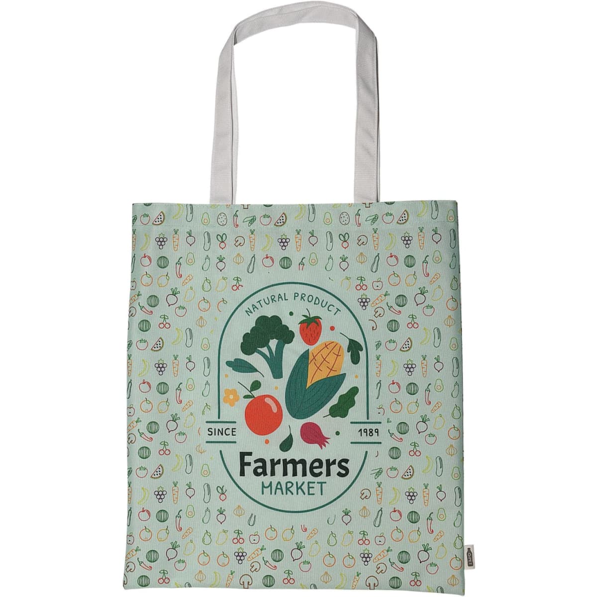 A green tote bag featuring a variety of vegetables and a circular logo, with white handles and a patterned background.
