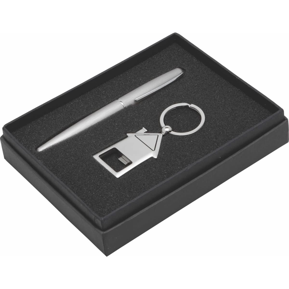 A silver pen, a metal keyring in the shape of a house, and a gift box with a black interior.