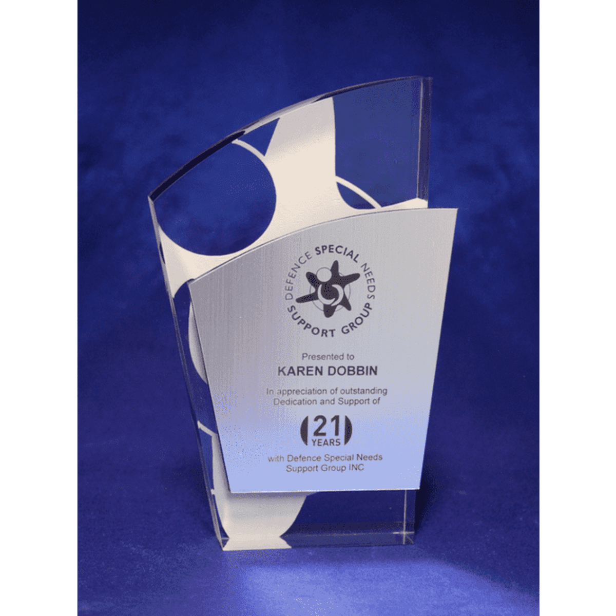 A contemporary acrylic trophy with a metallic facia, featuring laser engraving and a polished design in clear and silver.