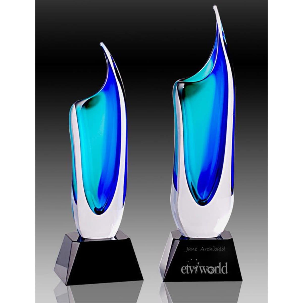 Art glass trophy vases in blue and green on a black base, featuring a sleek, modern design.