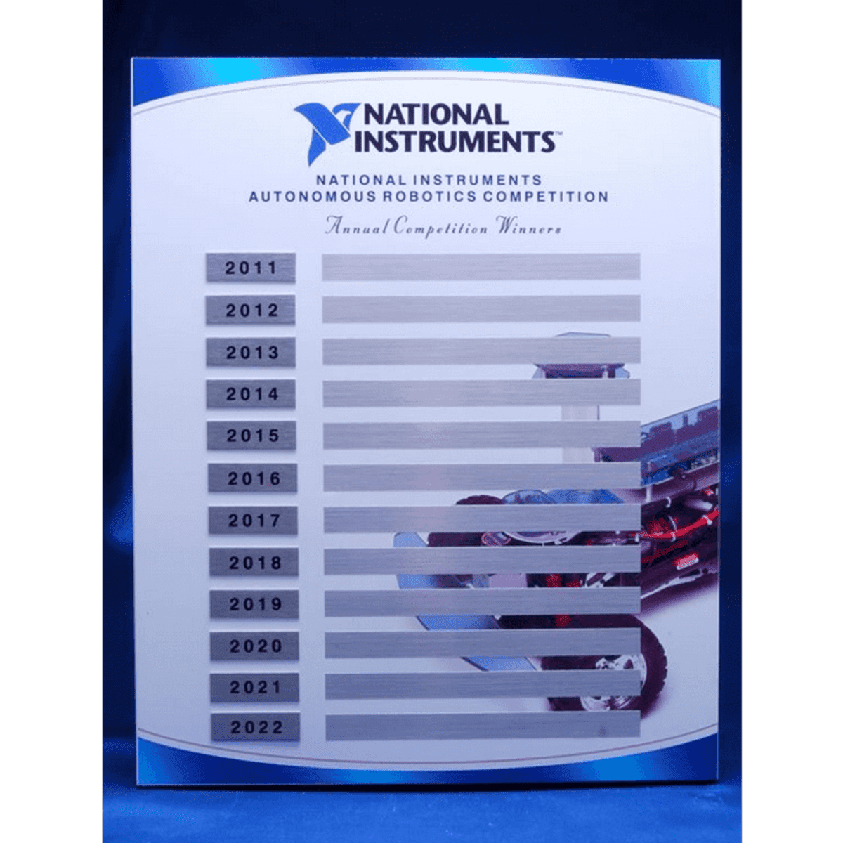 A plaque featuring a blue background with spaces for engraved names, celebrating annual competition winners from 2011 to 2022.