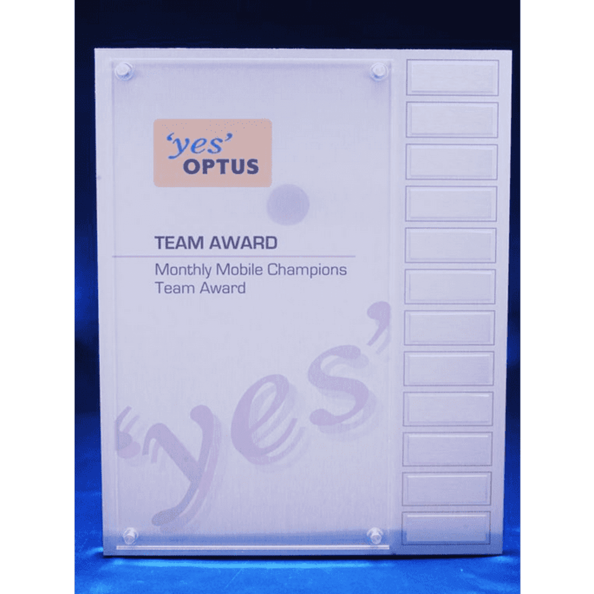 A clear acrylic award with an overlay, featuring plates for engraving names and a logo at the top.
