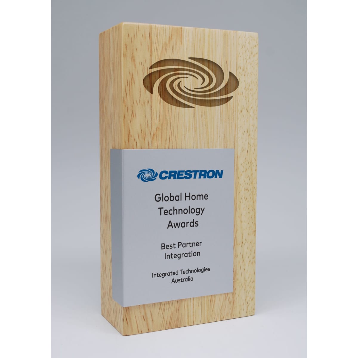 A wooden award with a printed metal plate, featuring a logo and text, set against a light grey background.