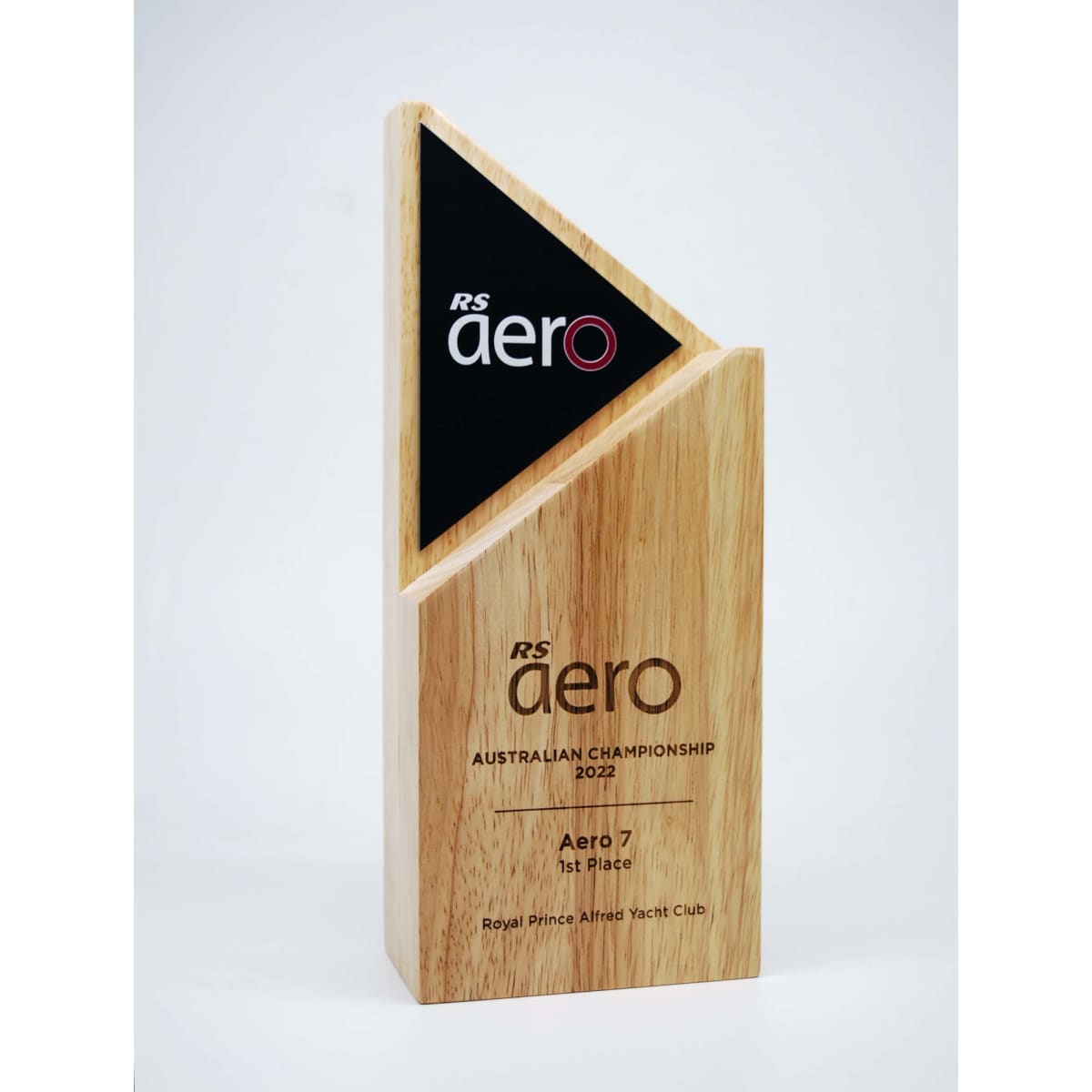 An Arrow Wood Award made of natural wood with a matte black alloy feature, showcasing a triangular design.