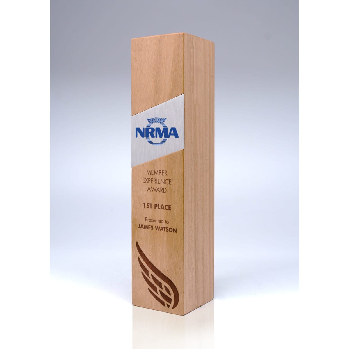 A wooden trophy in light brown, featuring a sleek design and a logo. It has a rectangular shape and a polished finish.