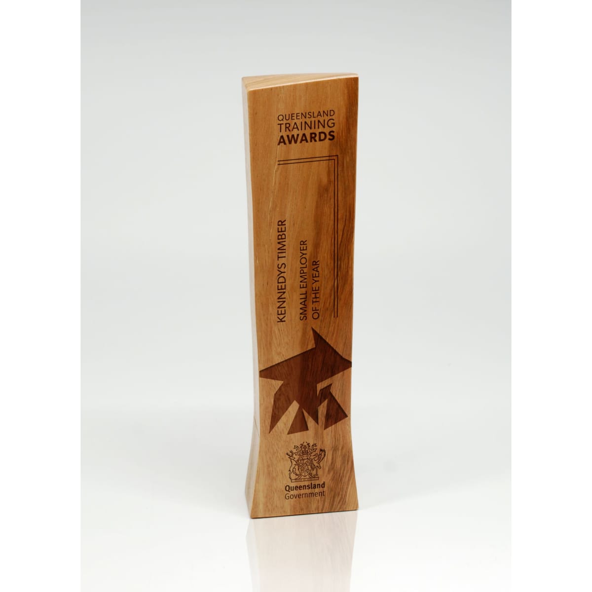 A trophy made of light brown timber with a sleek, modern design and a logo.