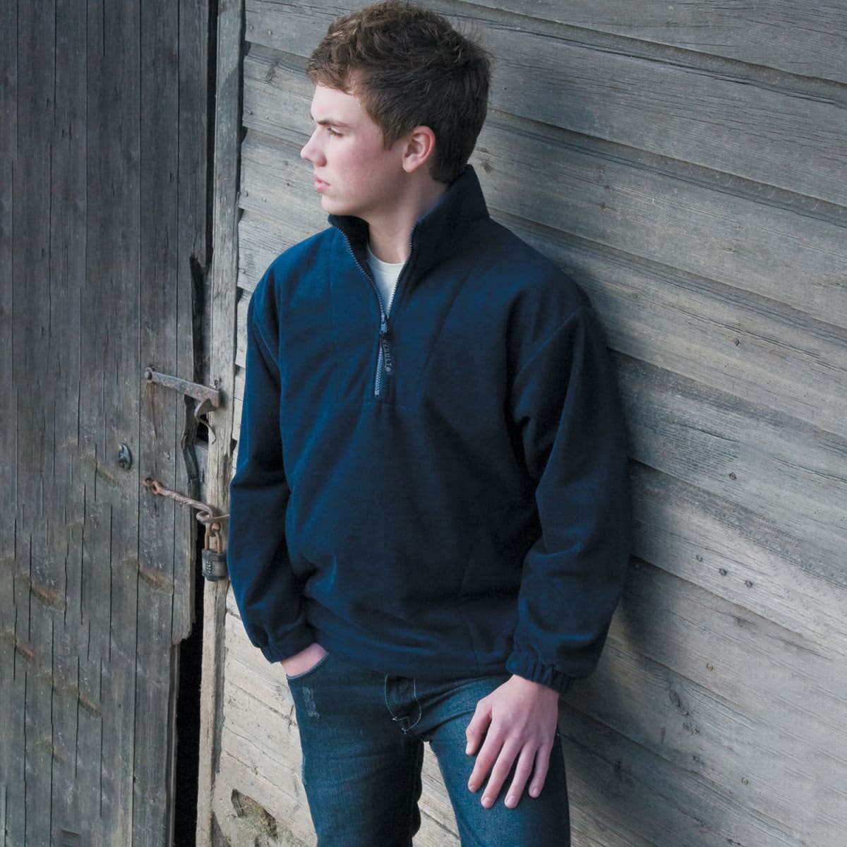 A navy blue quarter zip top made of polar fleece, featuring a standing collar and relaxed fit. It has a logo.