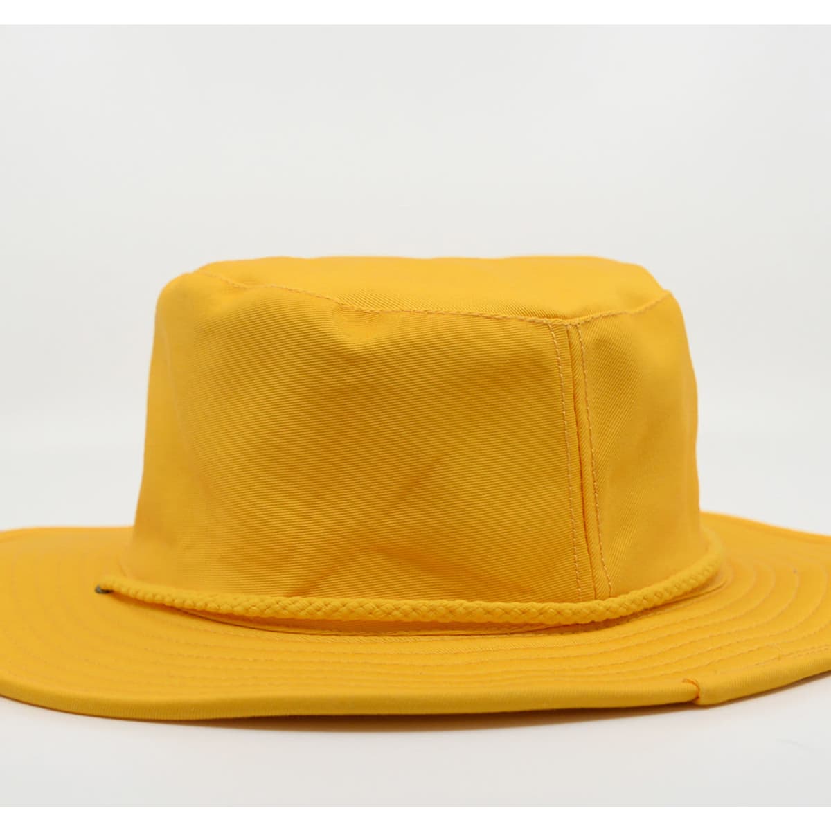 A wide-brimmed hat in bright yellow, featuring a textured band and a solid design. It has a logo on it.