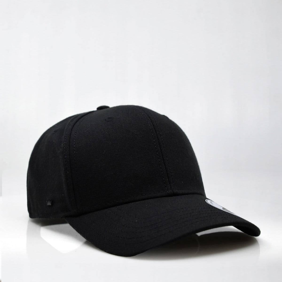 A black six-panel snapback cap featuring a logo on the side and a curved brim.