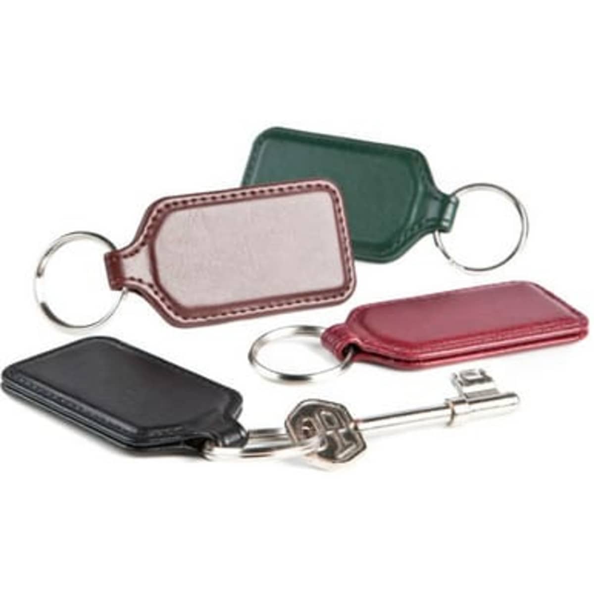Vivid rectangular key rings in black, green, maroon, and silver, each with a keyring attached.