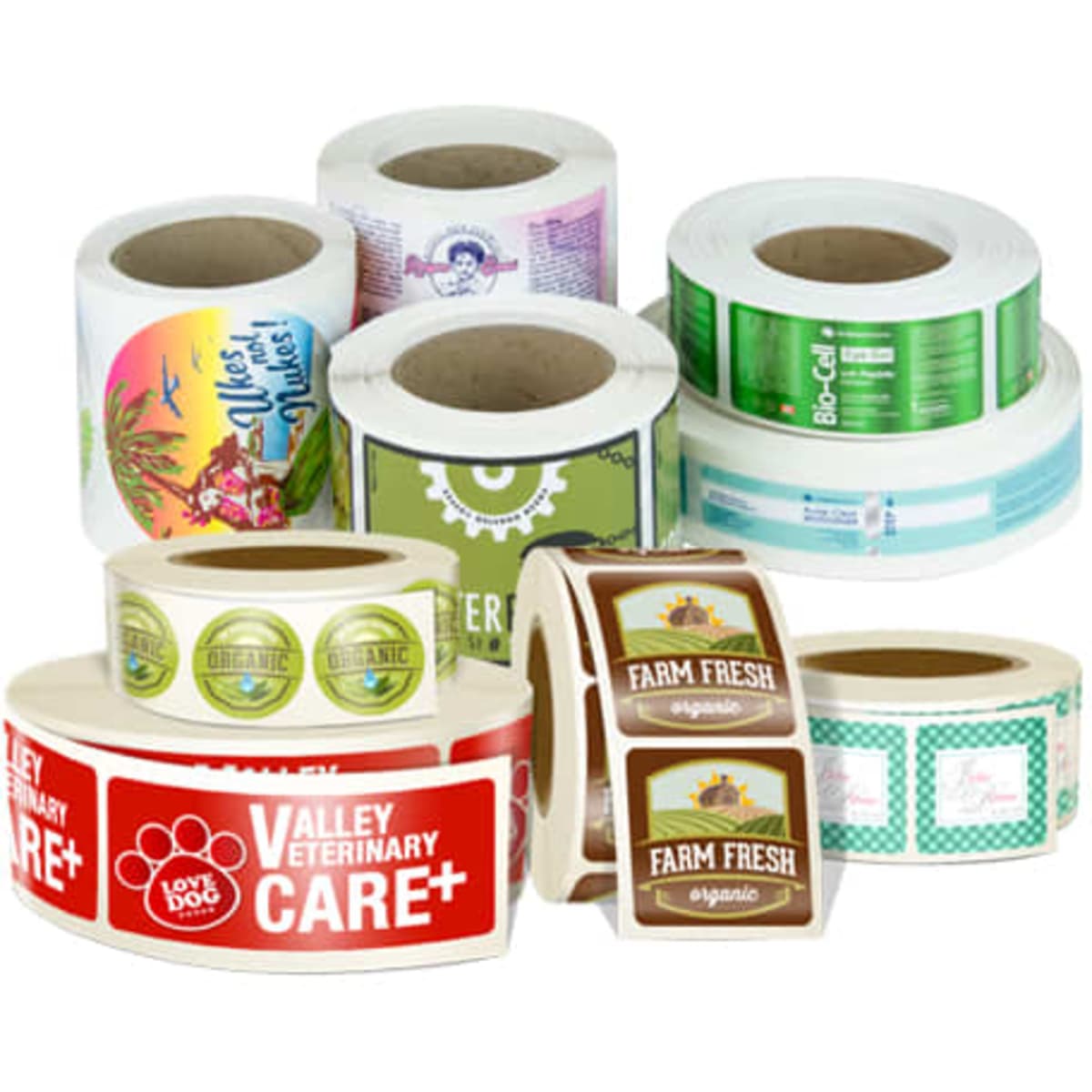 Rolls of printed stickers in various designs and colours, including some with logos and branding.