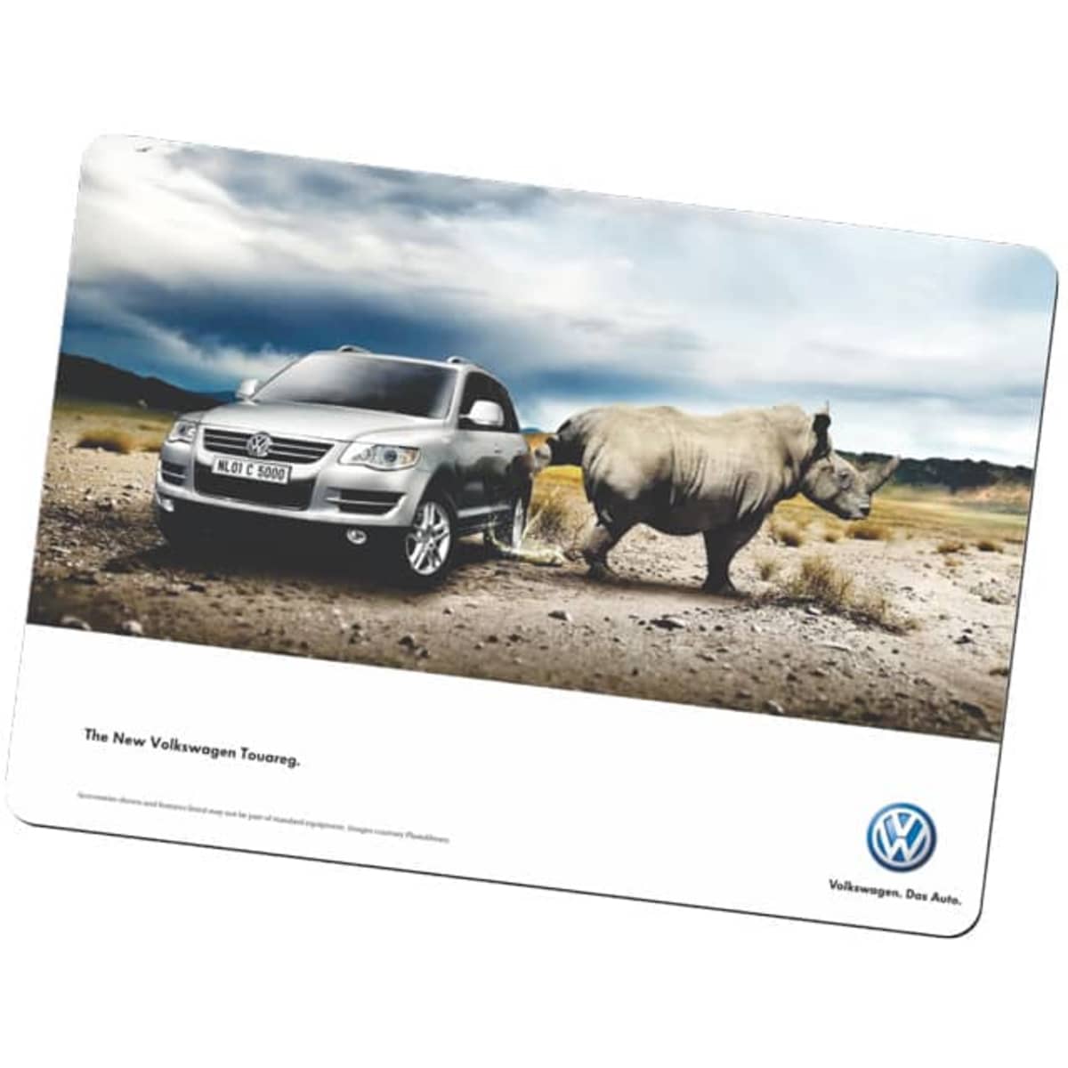 A counter mat featuring a grey SUV beside a rhinoceros in a desert landscape, with a logo at the bottom.