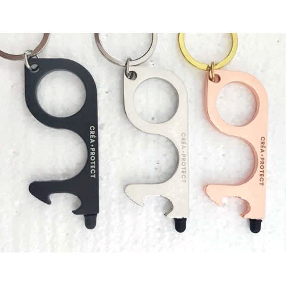 A set of three stylus no-touch door openers in black, silver, and rose gold, featuring a keyring and a logo.