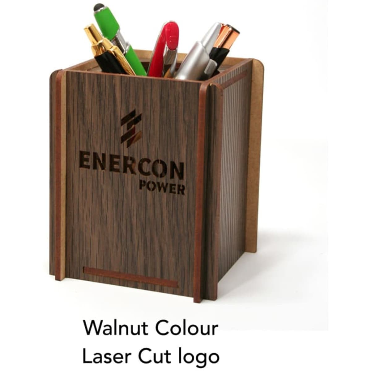 A walnut-coloured pen caddy with laser cut logo, holding various writing instruments.