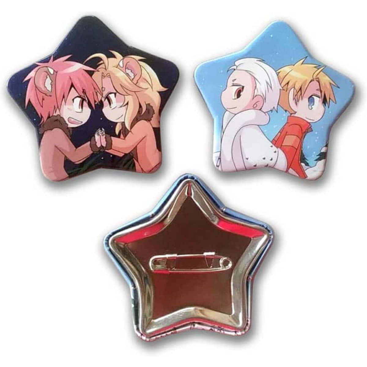 Three star-shaped button badges featuring colourful animated designs, including characters in playful poses. One has a shiny silver back.