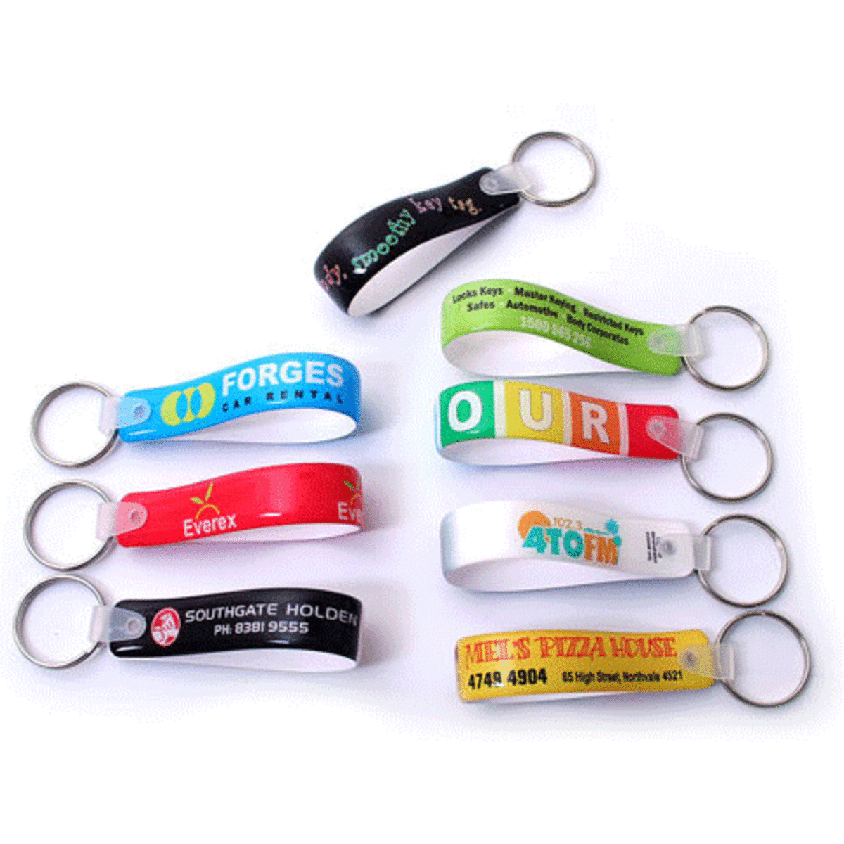 A collection of colourful promotional keyrings featuring various designs and a metallic keyring attachment.