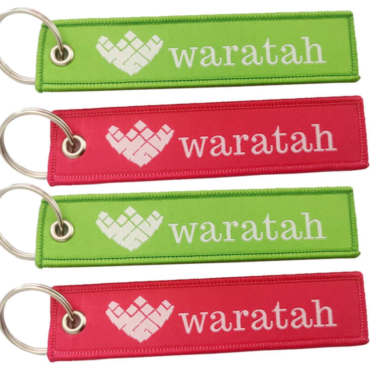 A set of woven keyrings in red and green, featuring a logo and text. Each keyring includes a metal keyring attachment.