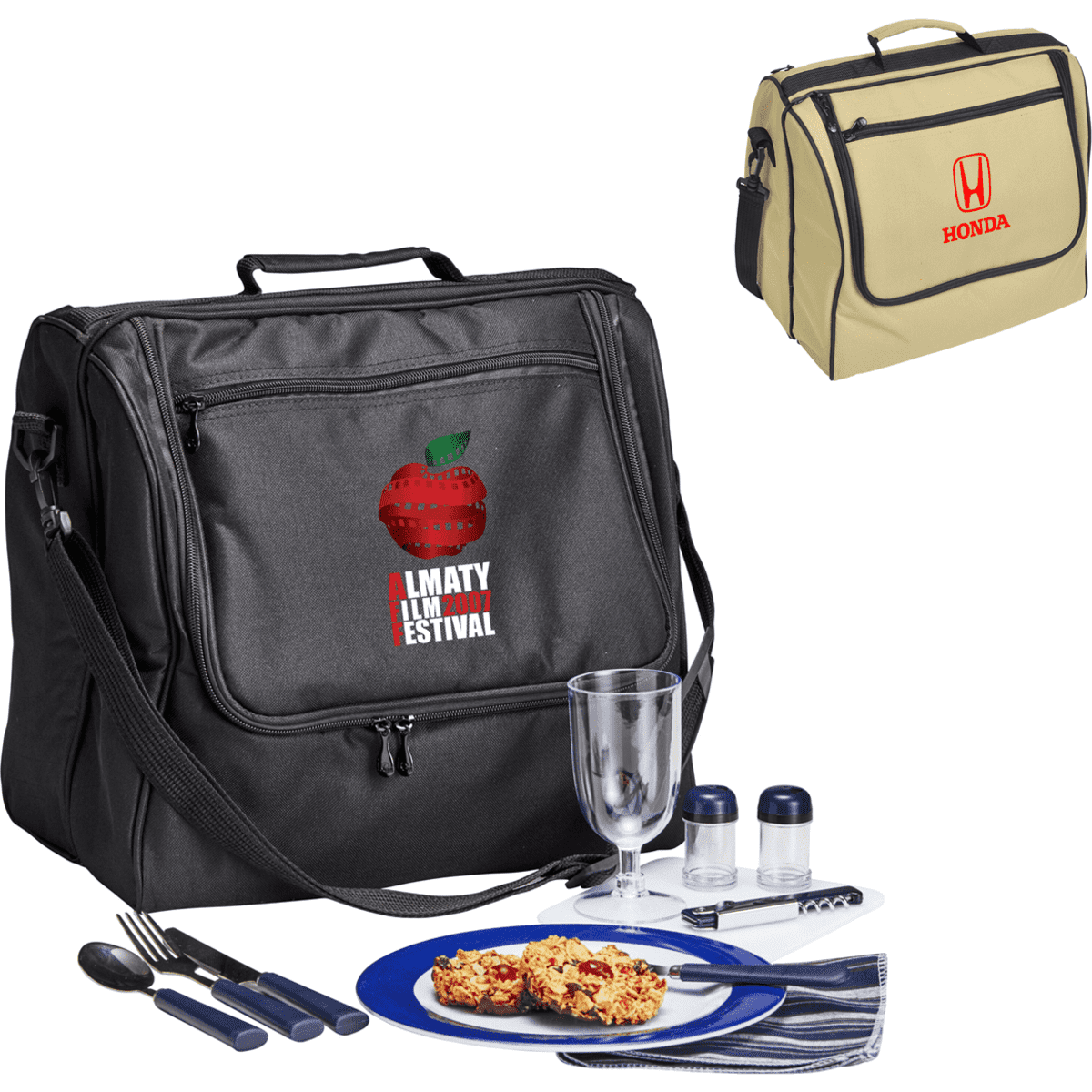 A black picnic bag with cutlery, a plate of food, and a drink glass. A beige bag with a logo is also visible.