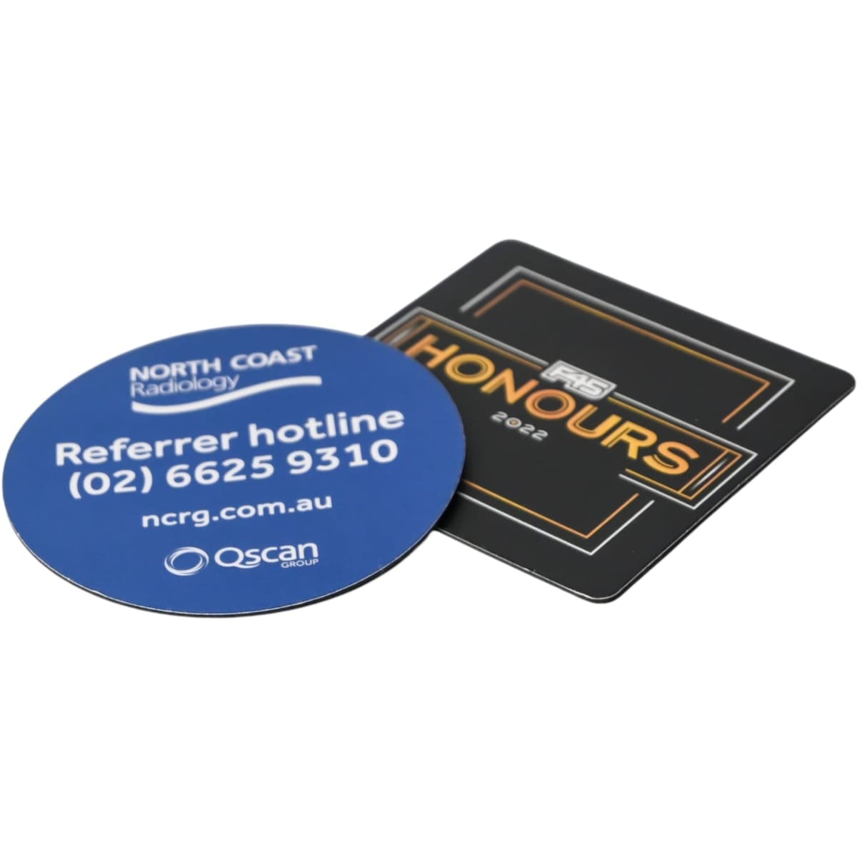 A round blue coaster and a square black coaster, both featuring logos and text.