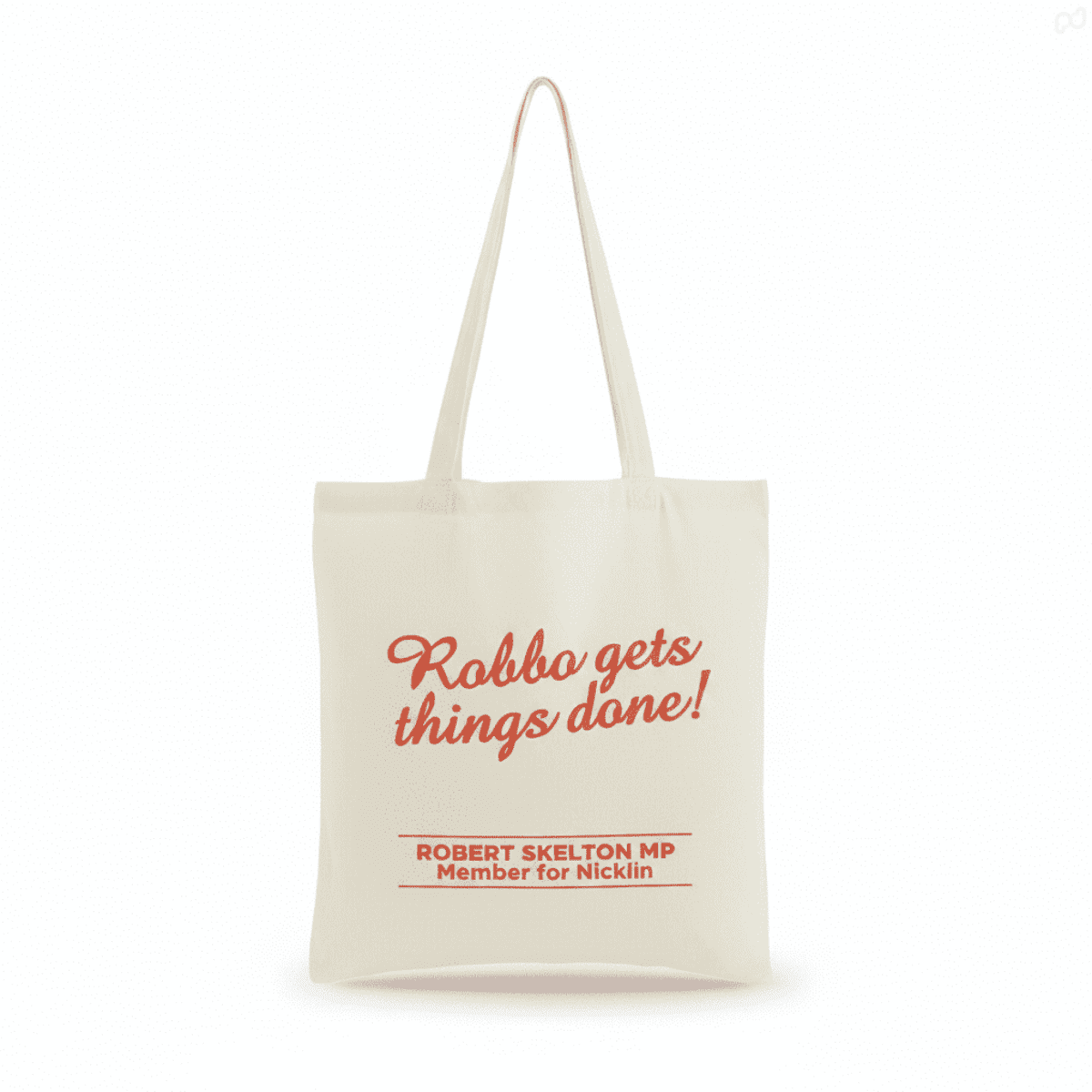 A Calico Tote Bag in cream with red text and a logo. Features sturdy handles for easy carrying.