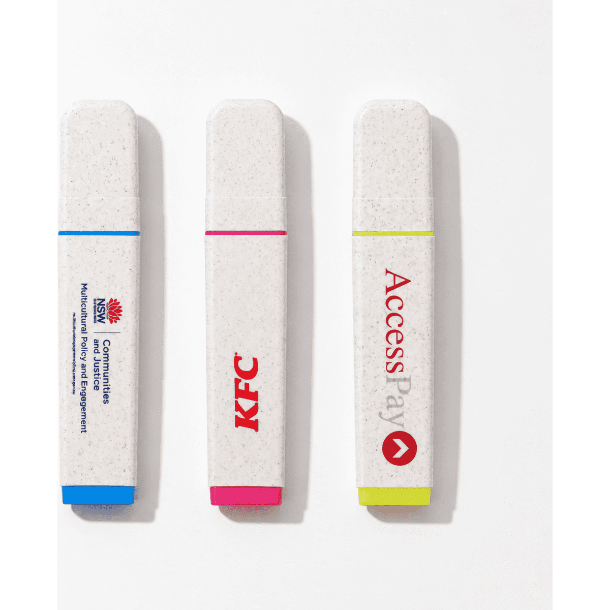 Three highlighters in biodegradable casing: blue, pink, and yellow, featuring various logos.