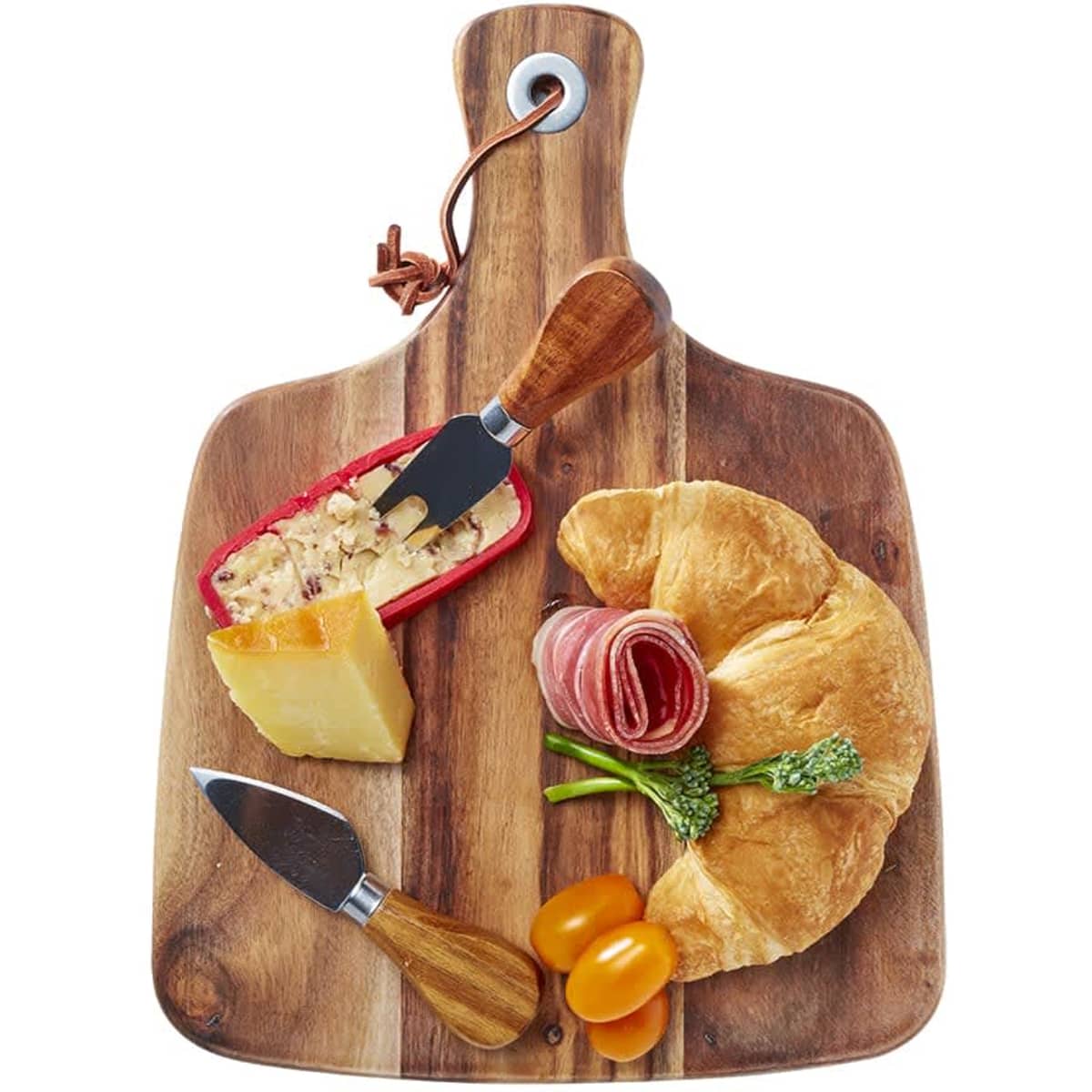 Acacia cheeseboard with knife set, featuring a wooden board, cheese, cured meats, croissant, and cherry tomatoes.