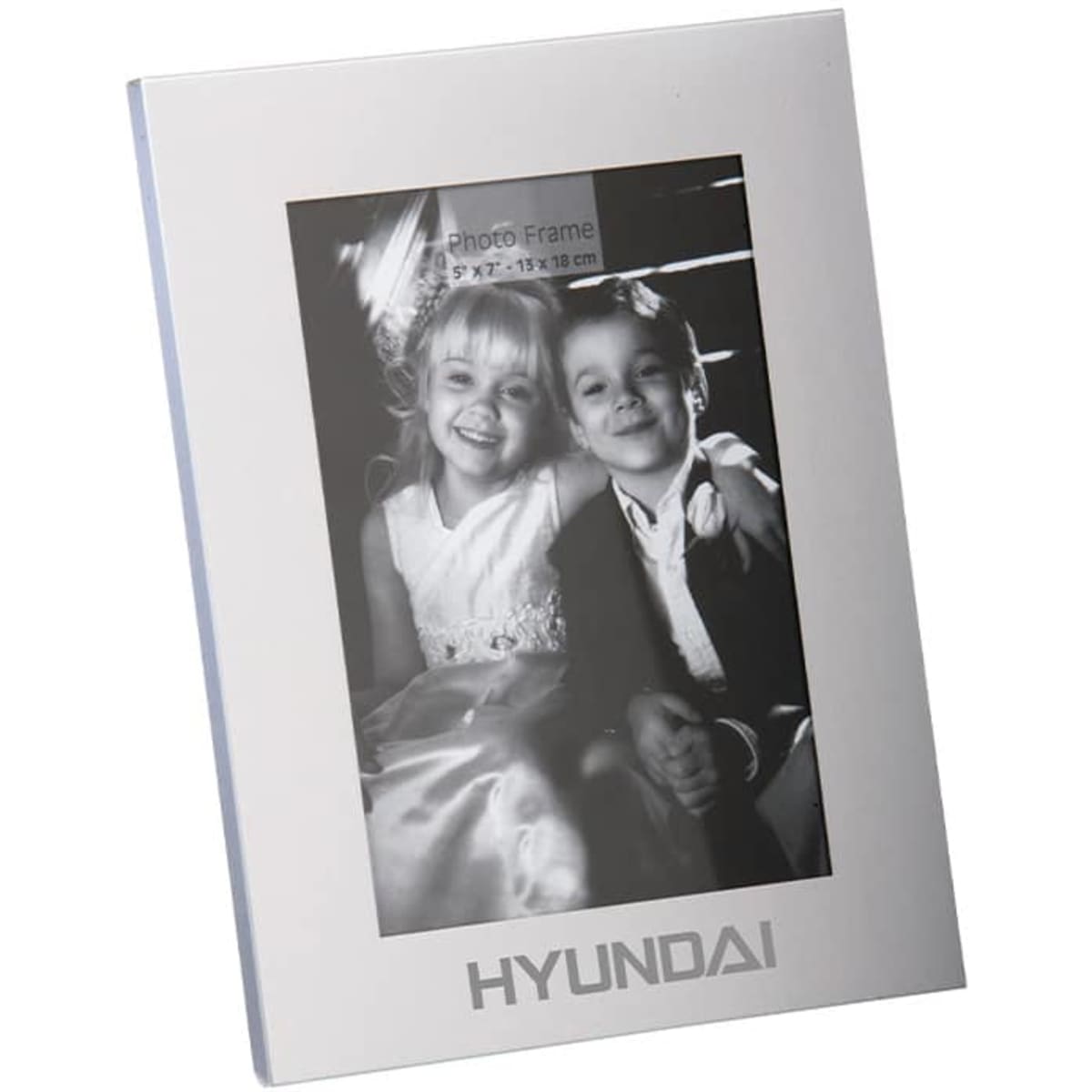 A classic aluminium photo frame in silver, featuring a black and white photo of two children. Includes a logo.