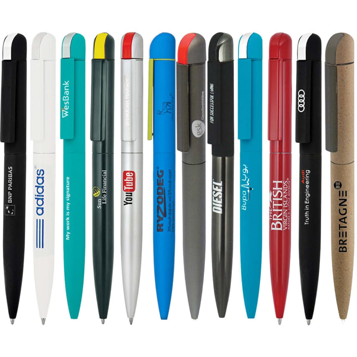 A collection of metal ballpoint pens in various colours, featuring logos and brand names, arranged in a line.