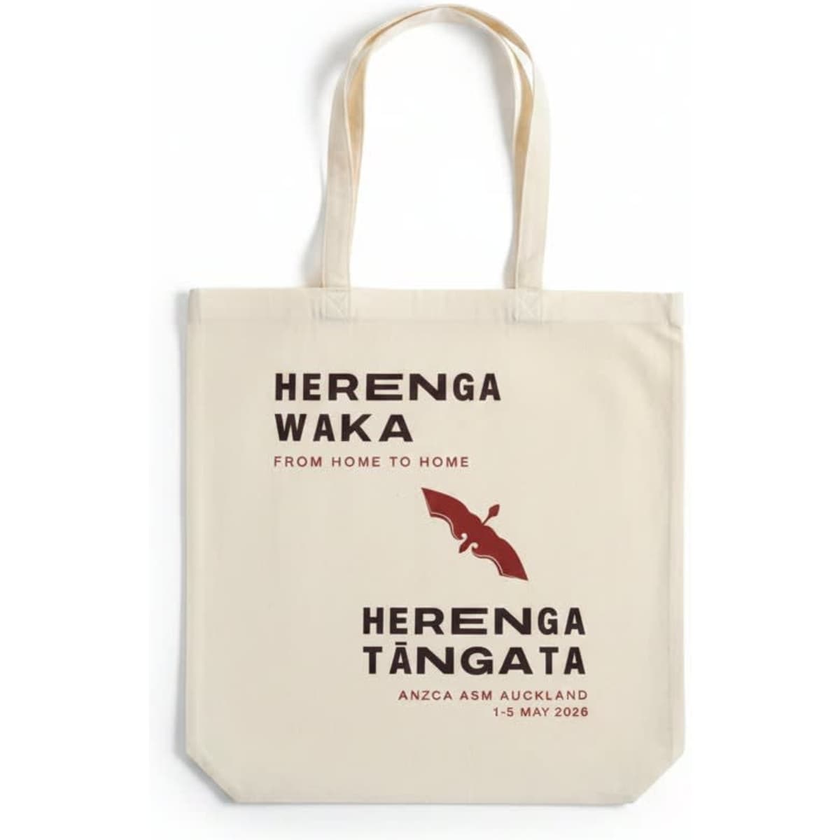 A cream tote bag with long handles featuring a logo, text, and a bat design in dark maroon.