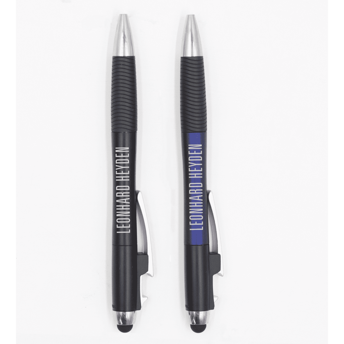 A pair of black pens with silver accents and branding, featuring rubber grips and stylus ends.