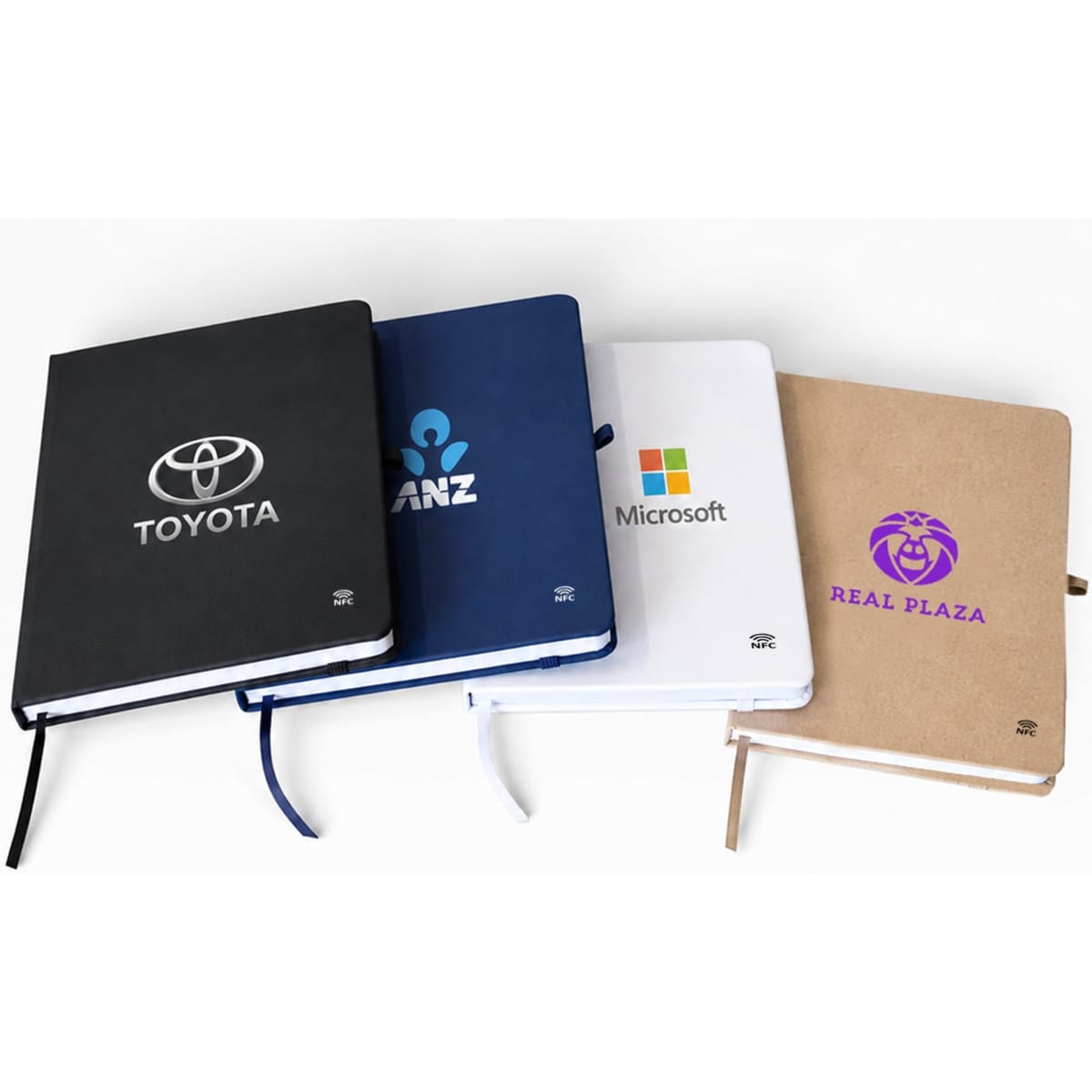 A set of four A5 smart notebooks in black, navy, white, and brown, featuring different logos on the covers.