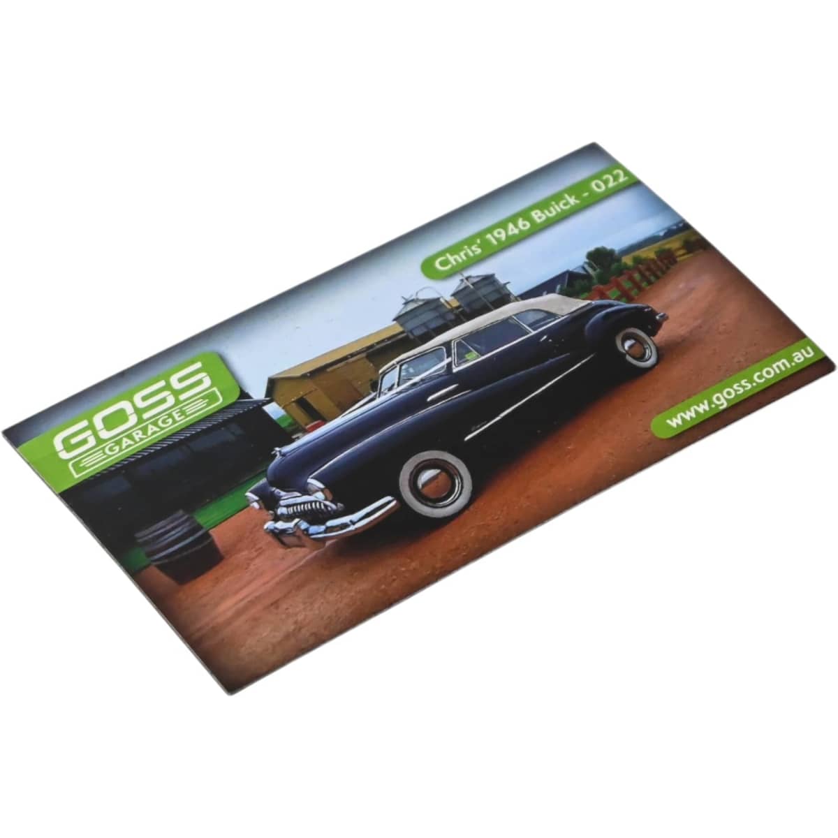 A rectangular fridge magnet featuring a 1948 Buick on a gravel road, with green branding elements.