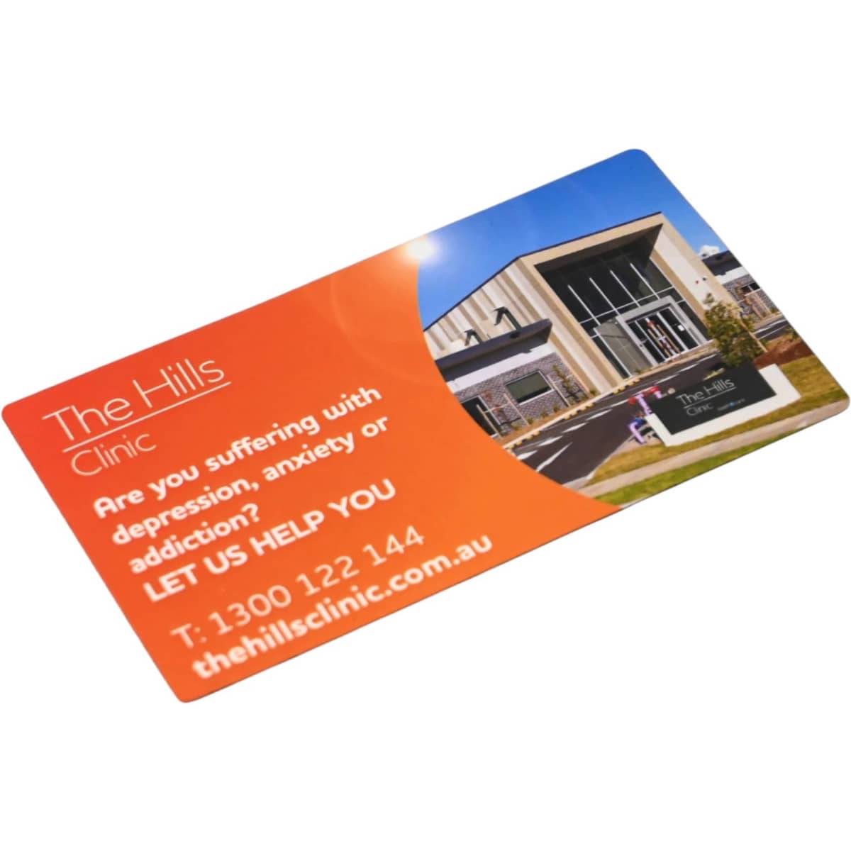 A rounded-corner fridge magnet featuring an orange and blue design with a modern building image.