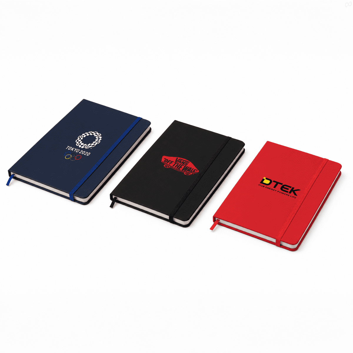 A set of three notebooks in navy, black, and red, each with a logo on the cover. Each notebook features a ribbon bookmark.