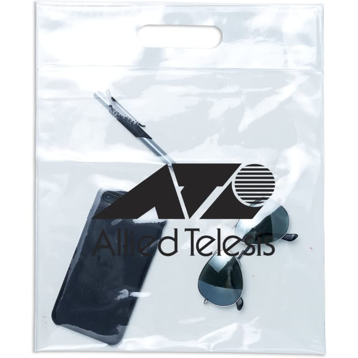 A clear tote bag contains a phone, sunglasses, and a pen, featuring a logo on the front.