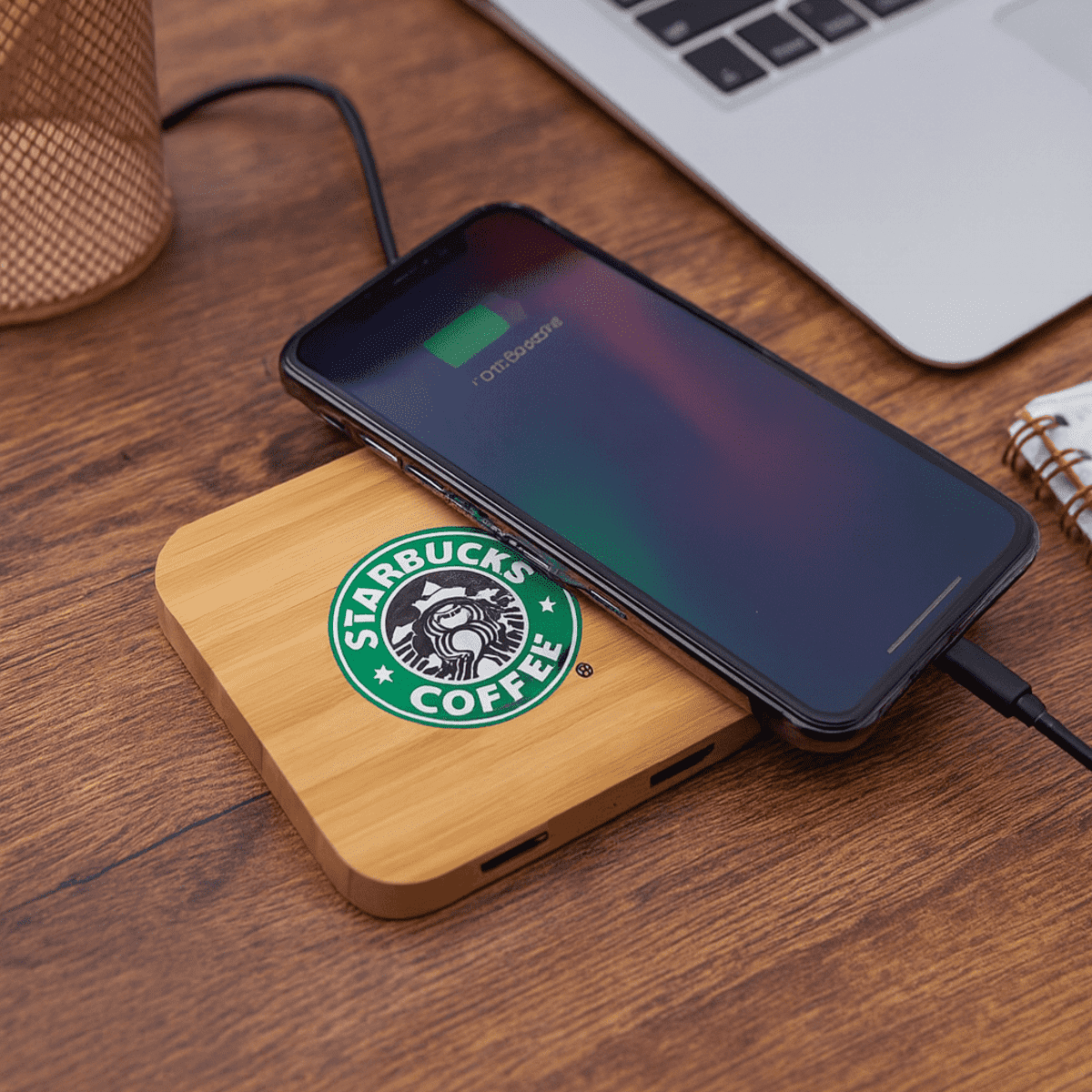 A bamboo wireless charging dock with a phone on top, featuring a logo and placed on a wooden surface.