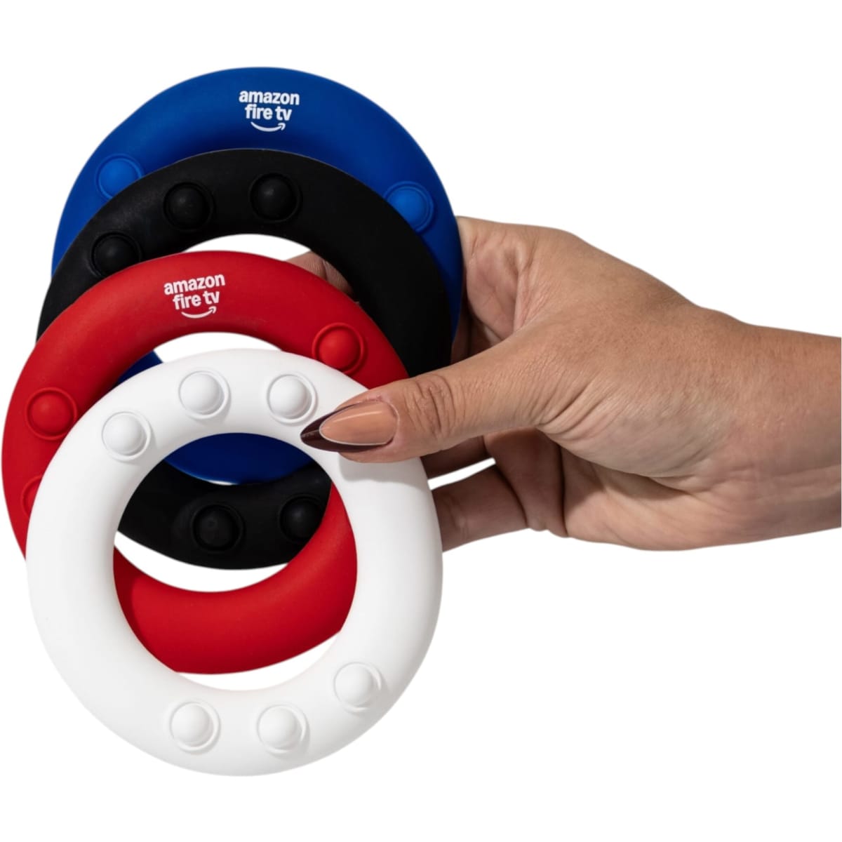 A hand holding three silicon wrist discs in red, black, blue, and white, featuring a logo.